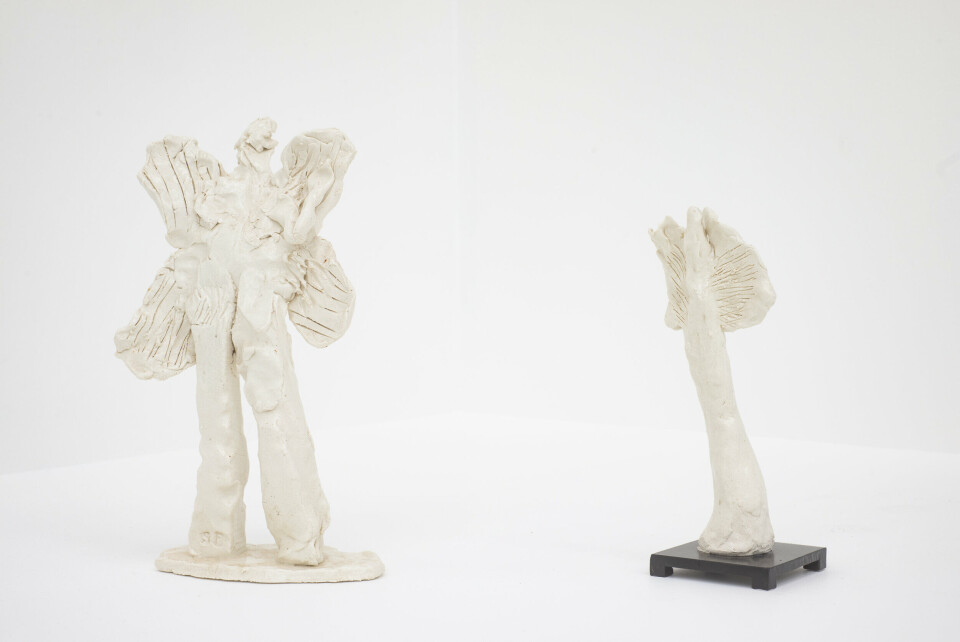 On the left: Simone Fattal, Pazouzou, démon du vent, 2013. Porcelain. 36 x 19 x 11 cm. Courtesy the artist. On the right: Simone Fattal, Angel, 2013. Porcelain, metal base. 29 x 10 x 10 cm. Courtesy the artist. Photo: Thor Brødreskift On the left: Simone Fattal, Pazouzou, démon du vent, 2013. Porcelain. 36 x 19 x 11 cm. Courtesy the artist. On the right: Simone Fattal, Angel, 2013. Porcelain, metal base. 29 x 10 x 10 cm. Courtesy the artist. Photo: Thor Brødreskift